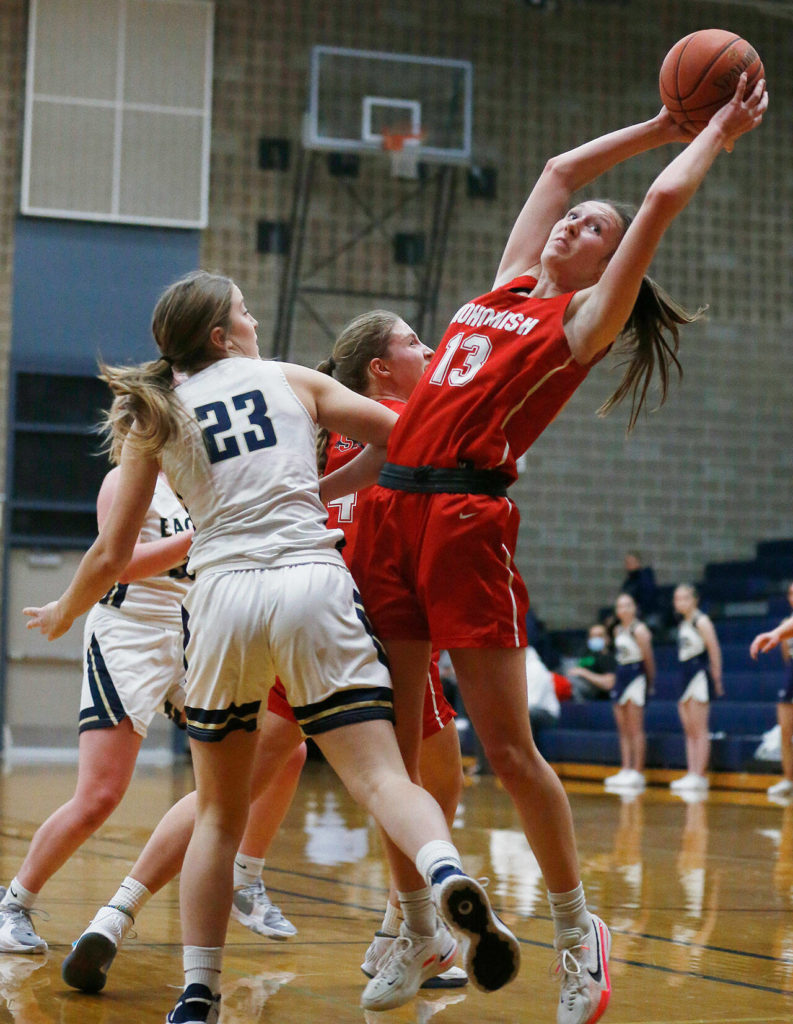 Snohomish’s Ella Gallatin grabs an offensive rebound during a game against Arlington on Monday at Arlington High School. (Ryan Berry / The Herald)
