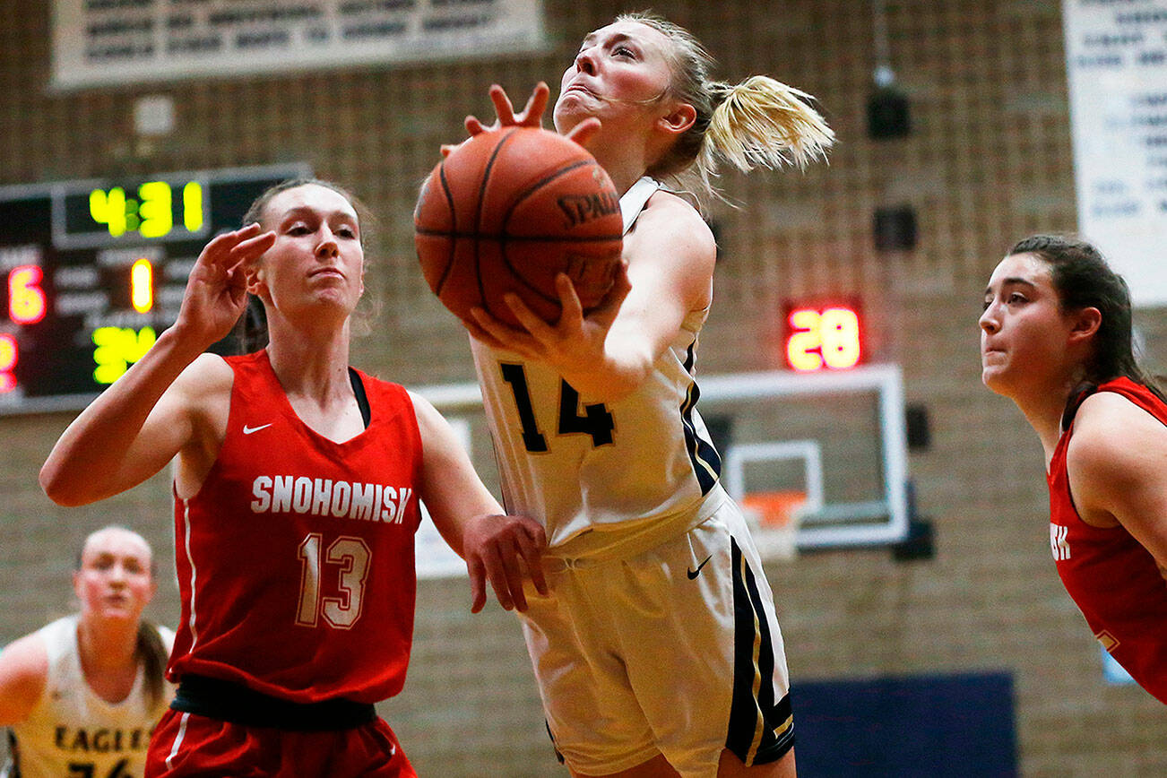 Arlington’s Keira Marsh gos for a layup against Snohomish on Monday, Jan. 24, 2022 at Arlington High School. (Ryan Berry / The Herald)