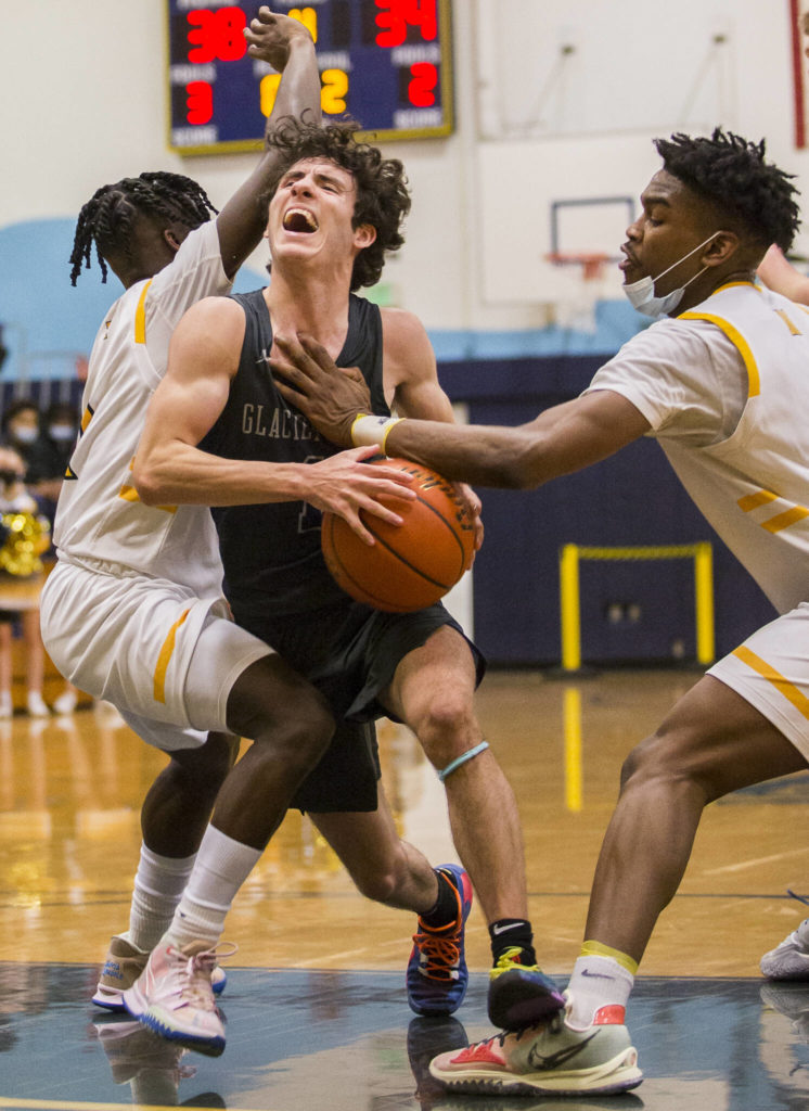 Glacier Peak’s Aidan Davis yells while being fouled by Mariner’s Dakota Joseph during the game on Tuesday, Jan. 25, 2022 in Everett, Washington. (Olivia Vanni / The Herald)
