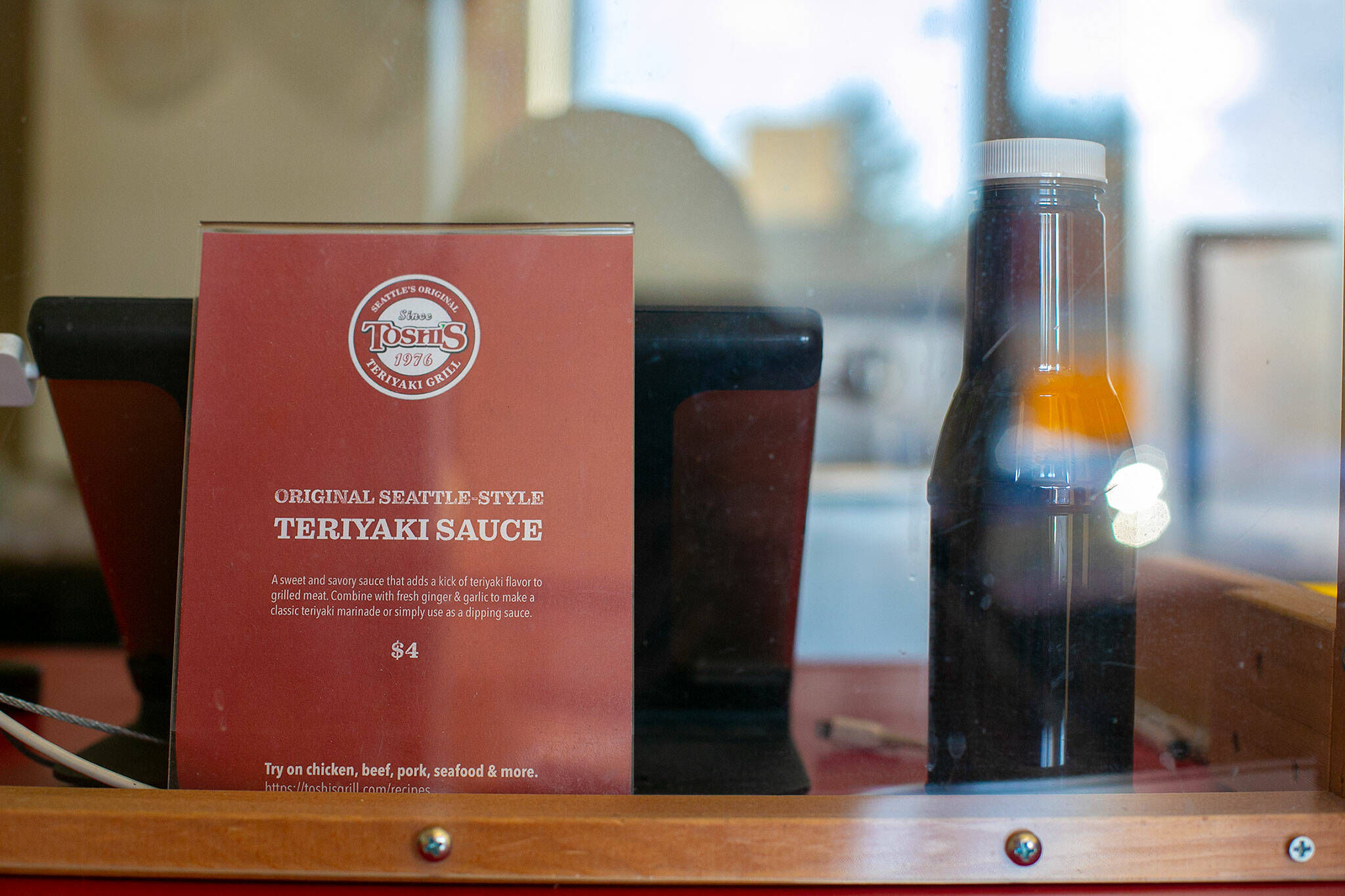 A bottle of Toshi’s signature teriyaki sauce is for sale at Toshi’s Teriyaki Grill in Mill Creek. (Ryan Berry / The Herald)