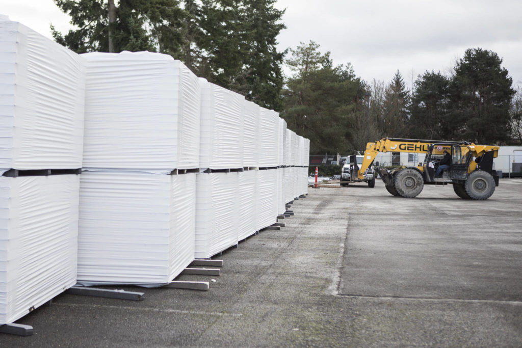 Construction materials are delivered to the new Helion Energy headquarters in Everett. (Olivia Vanni / The Herald) 
