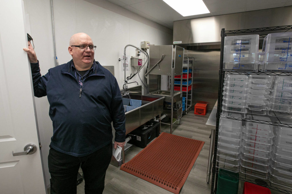 Edmund Smith stands in the kitchen at the new Holman Recovery Center in Smokey Point on Friday. (Ryan Berry / The Herald)

