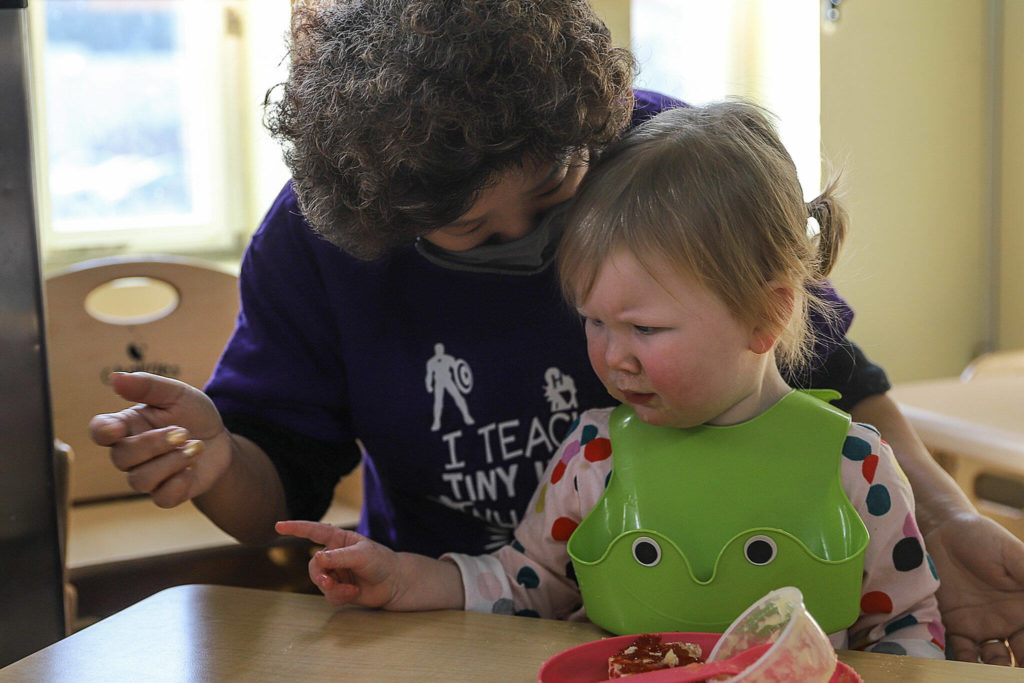 Hannah Roberts (left) helps Miriam, 2, with snack time at the Edmonds Lutheran Learning Center. (Kevin Clark / The Herald)
