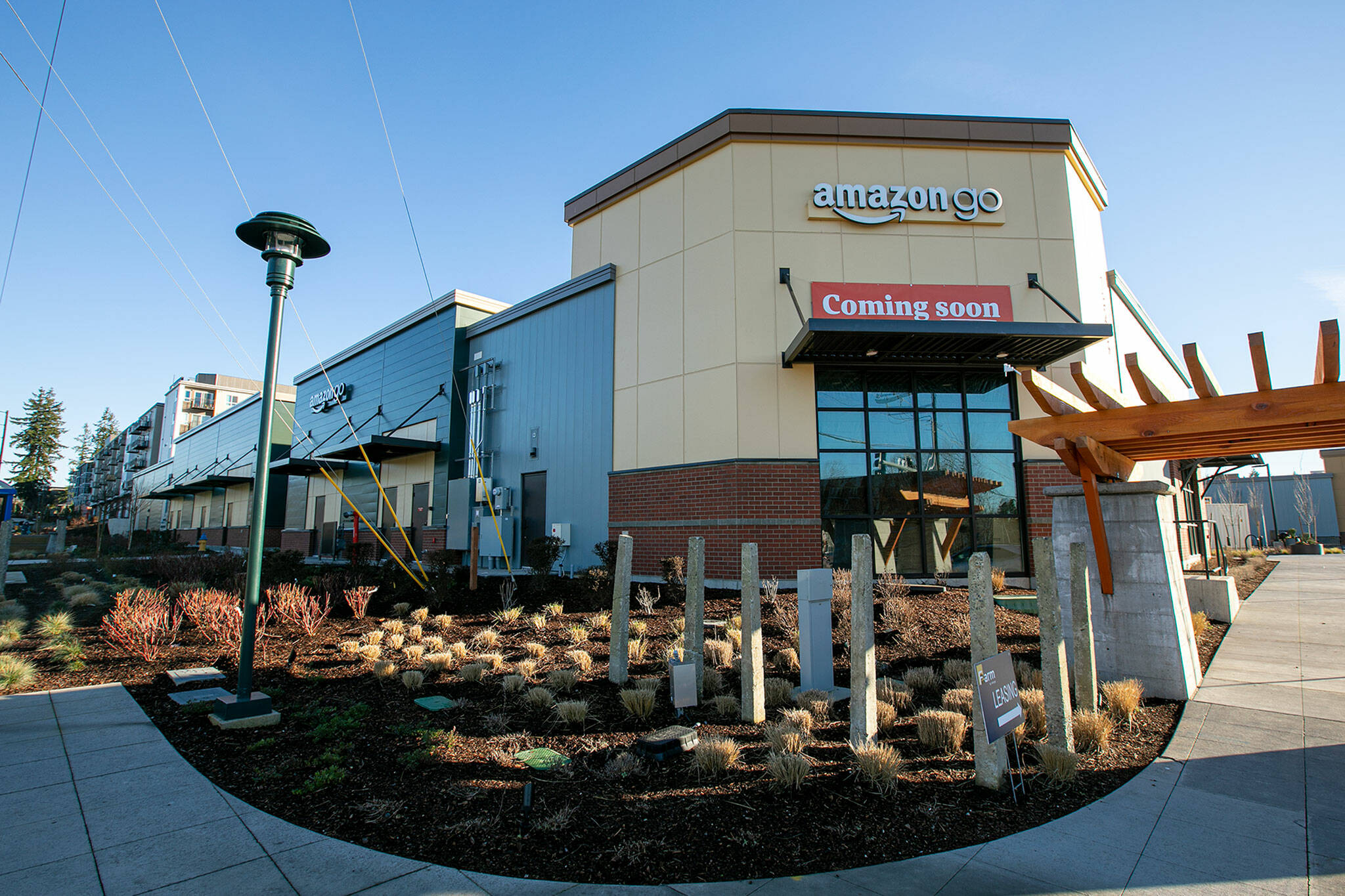 A sign is up on a new Amazon Go building along 132nd St SE in Mill Creek. The cashierless grab-and-go store is set to open in the coming months. (Ryan Berry / The Herald)