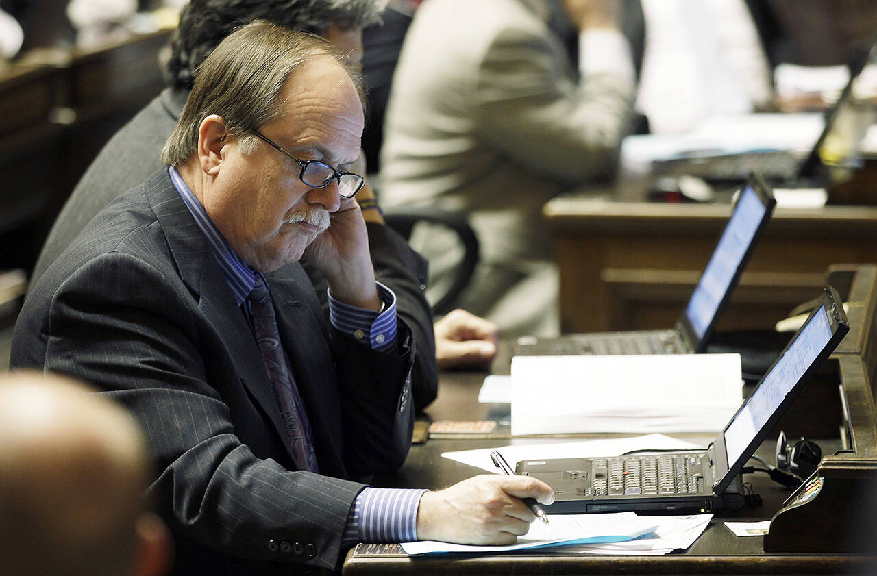 Rep. Mike Sells takes notes on the House floor at the Capitol in Olympia on April 13, 2011. (AP Photo/Ted S. Warren, file)