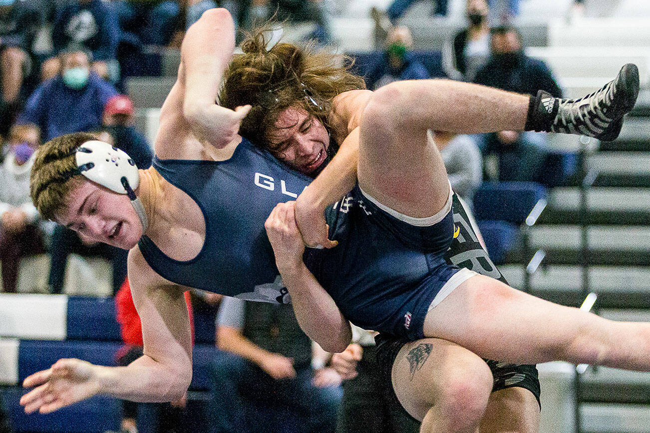 Lake Stevens' Tyler Fouts lifts Glacier Peak's Gil Mossburg during wrestling on Tuesday, Jan. 18, 2022 in Snohomish, Washington. (Olivia Vanni / The Herald)