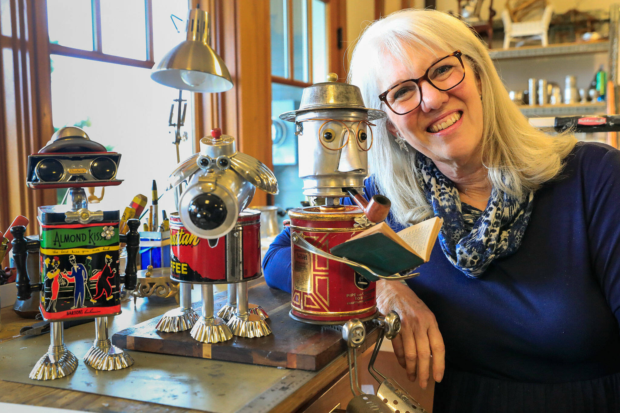 Amy Knutson of Everett takes old kitchenware, coffee kettles and other metals and turns them into 1-foot-tall sculptures of robots. (Kevin Clark / The Herald)