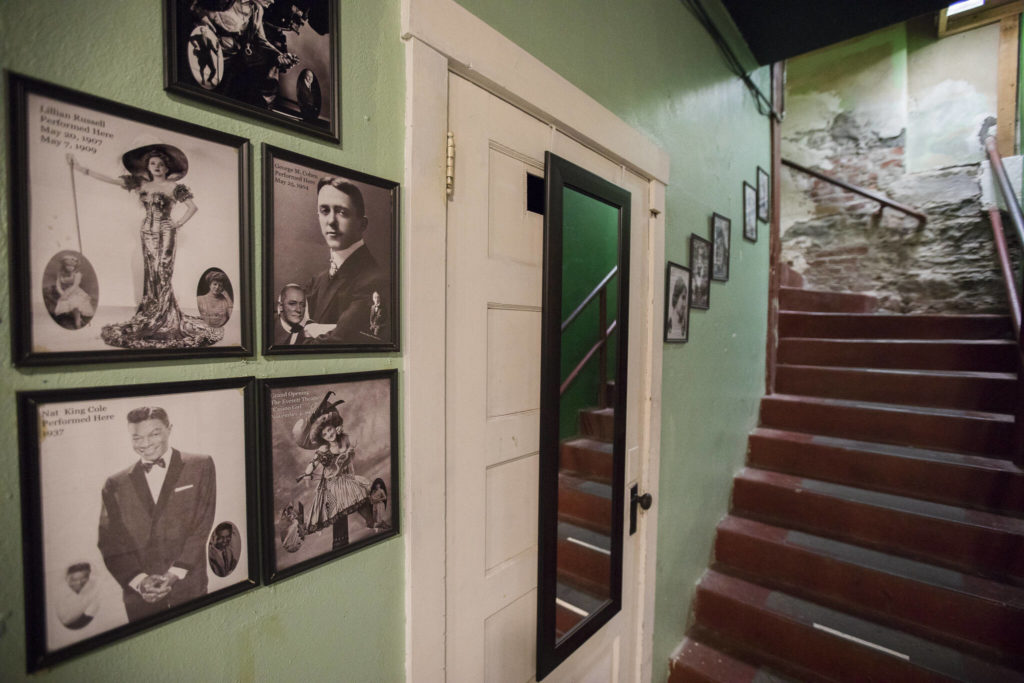 Posters cover the walls along the stairway leading into the green room at the Historic Everett Theatre. (Olivia Vanni / The Herald)
