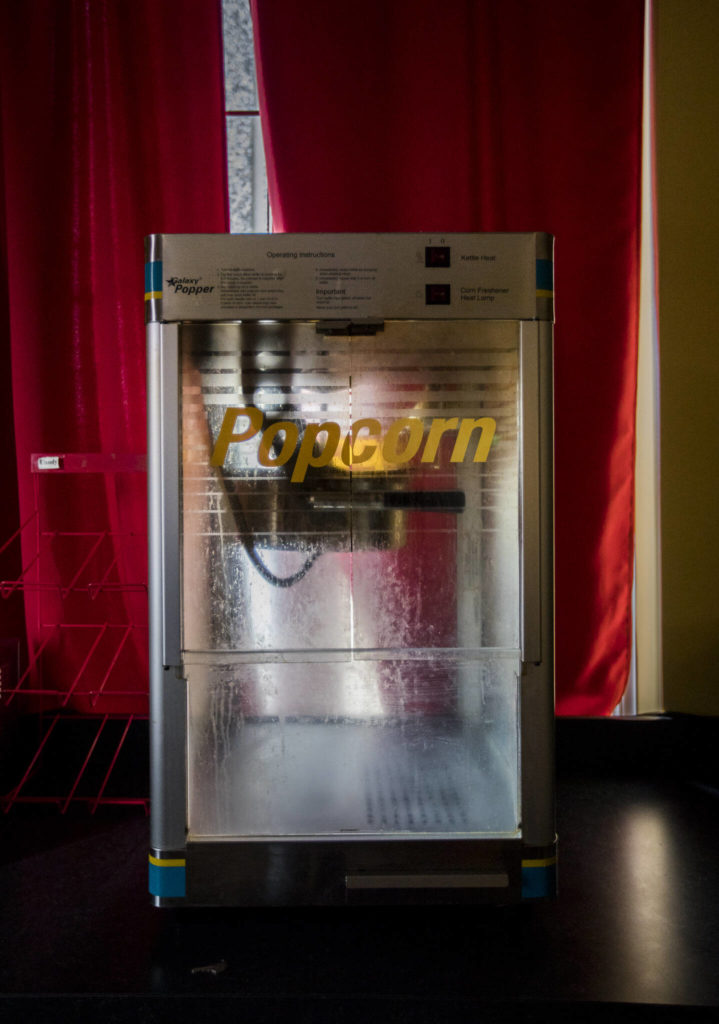 Oil coats the inside of an old popcorn machine at the Historic Everett Theatre. (Olivia Vanni / The Herald)
