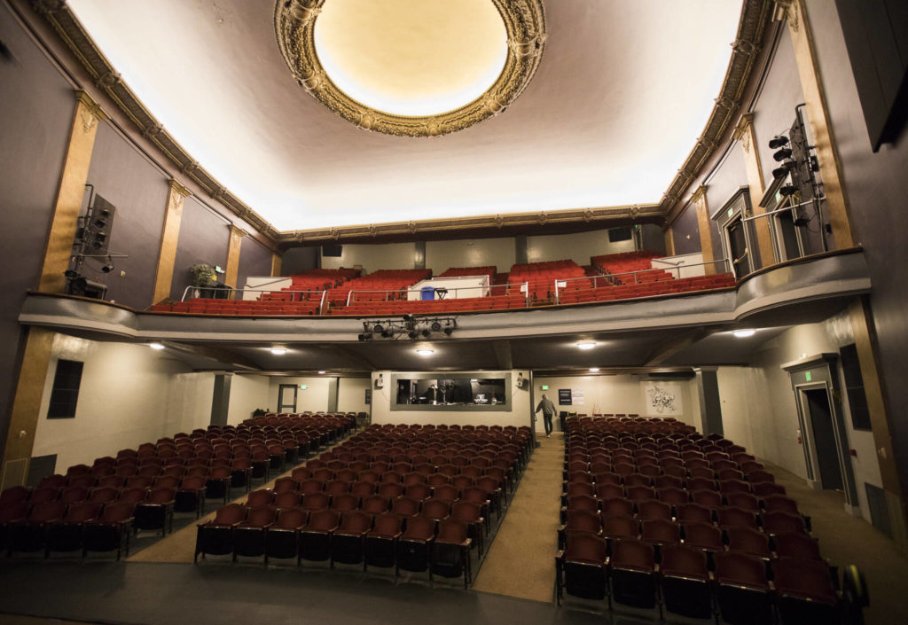 Curt Shriner walks into the technical booth at the Historic Everett Theatre. (Olivia Vanni / The Herald)
