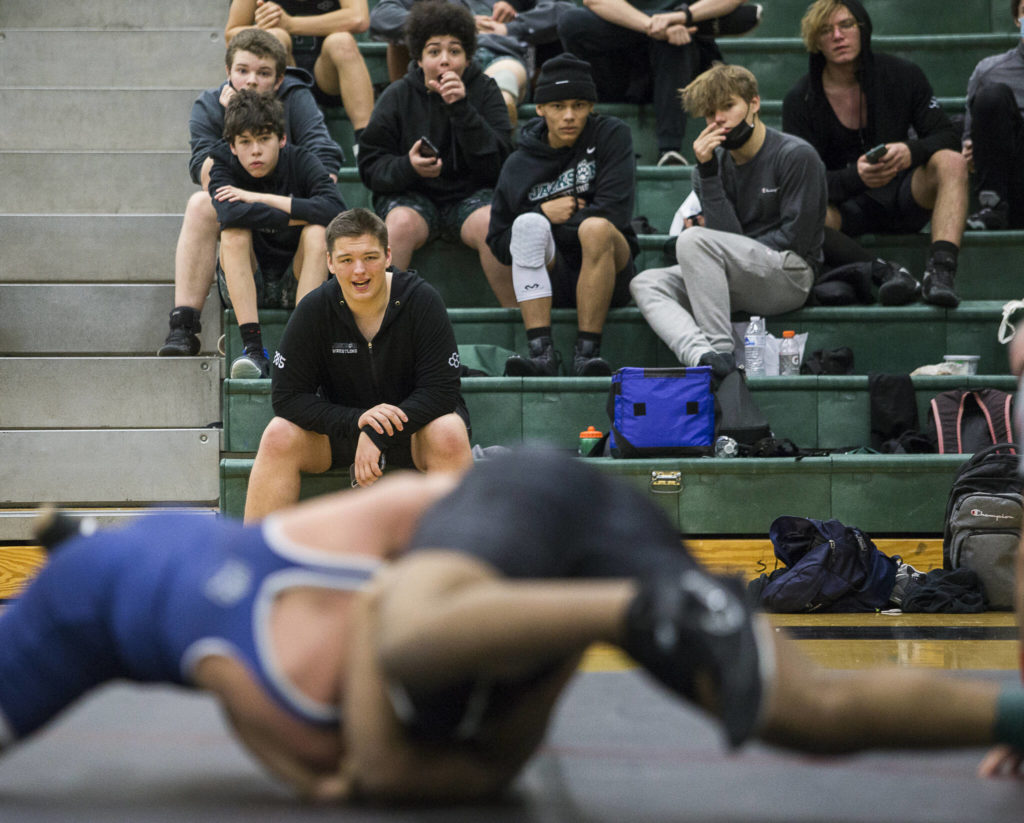 Jackson wrestlers cheer on their teammate during a 4A sub-regional match on Saturday at Henry M. Jackson High School in Mill Creek. (Olivia Vanni / The Herald)
