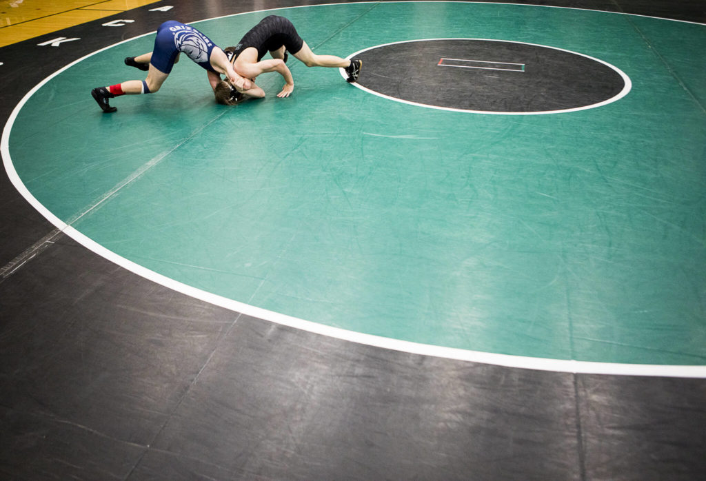 Glacier Peak and Jackson wrestlers compete during a 4A sub-regional match on Saturday at Henry M. Jackson High School in Mill Creek. (Olivia Vanni / The Herald)
