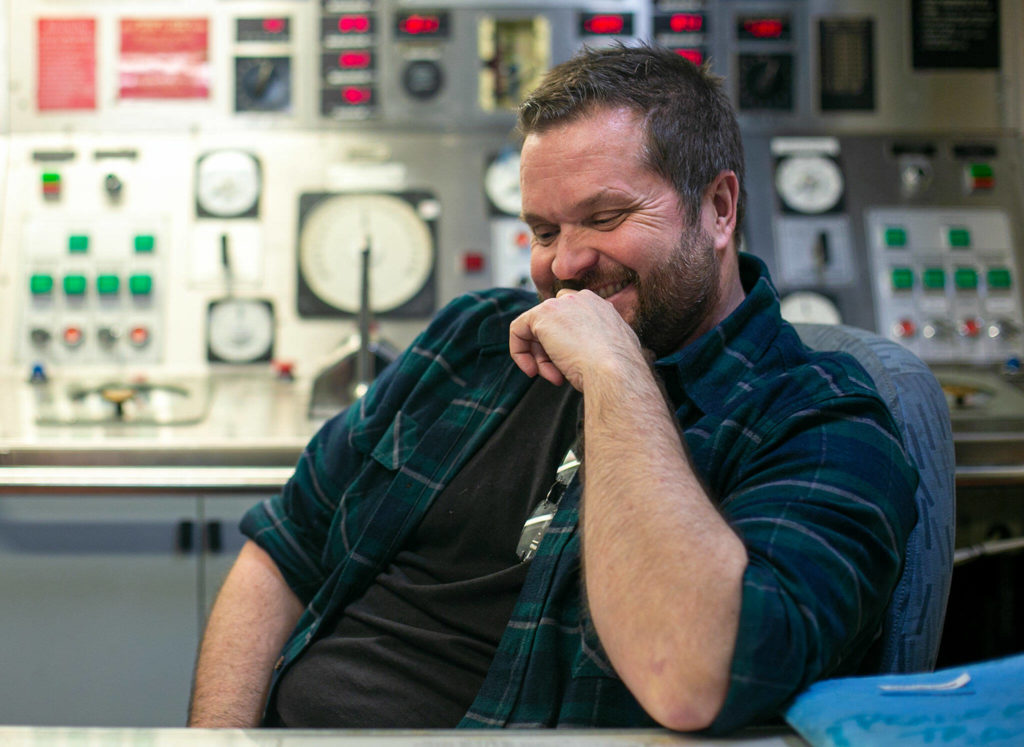 Bart Lematta sits inside the decommissioned Evergreen State ferry he bought at auction in 2020 for $290,000 and discusses the intricacies of how the vessel works. (Ryan Berry / The Herald)
