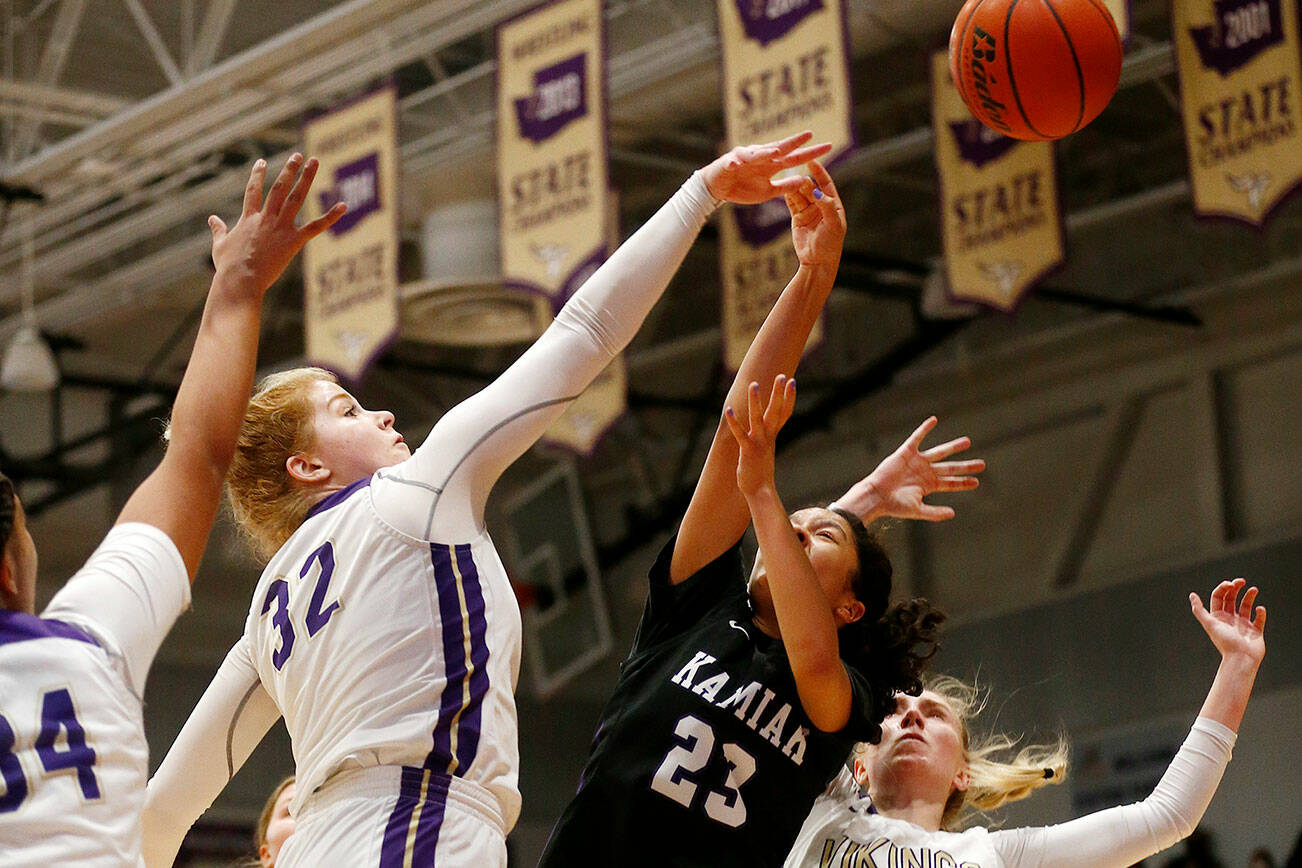 Lake Stevens’ Cori Wilcox records a block down low against Kamiak Monday, Feb. 7, 2022, at Lake Stevens High School in Lake Stevens, Washington. (Ryan Berry / The Herald)