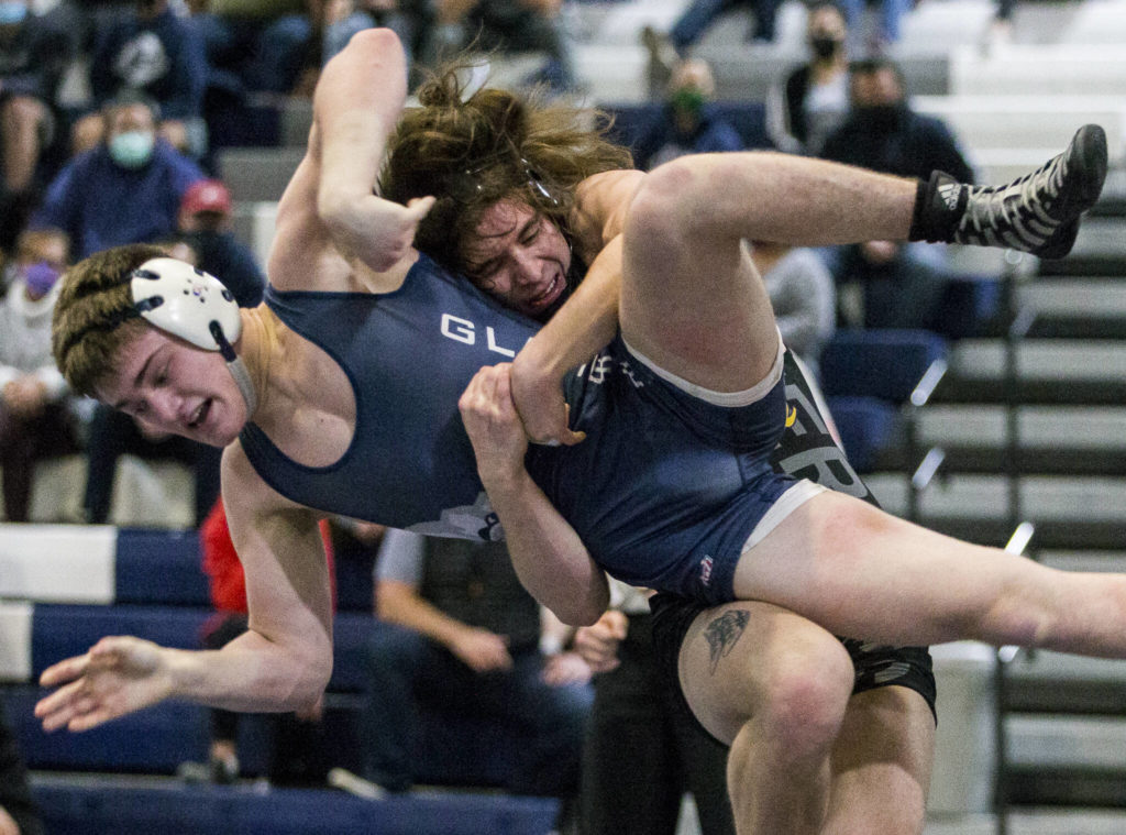 Lake Stevens’ Tyler Fouts lifts Glacier Peak’s Gil Mossburg during wrestling on Tuesday, Jan. 18, 2022 in Snohomish, Washington. (Olivia Vanni / The Herald)
