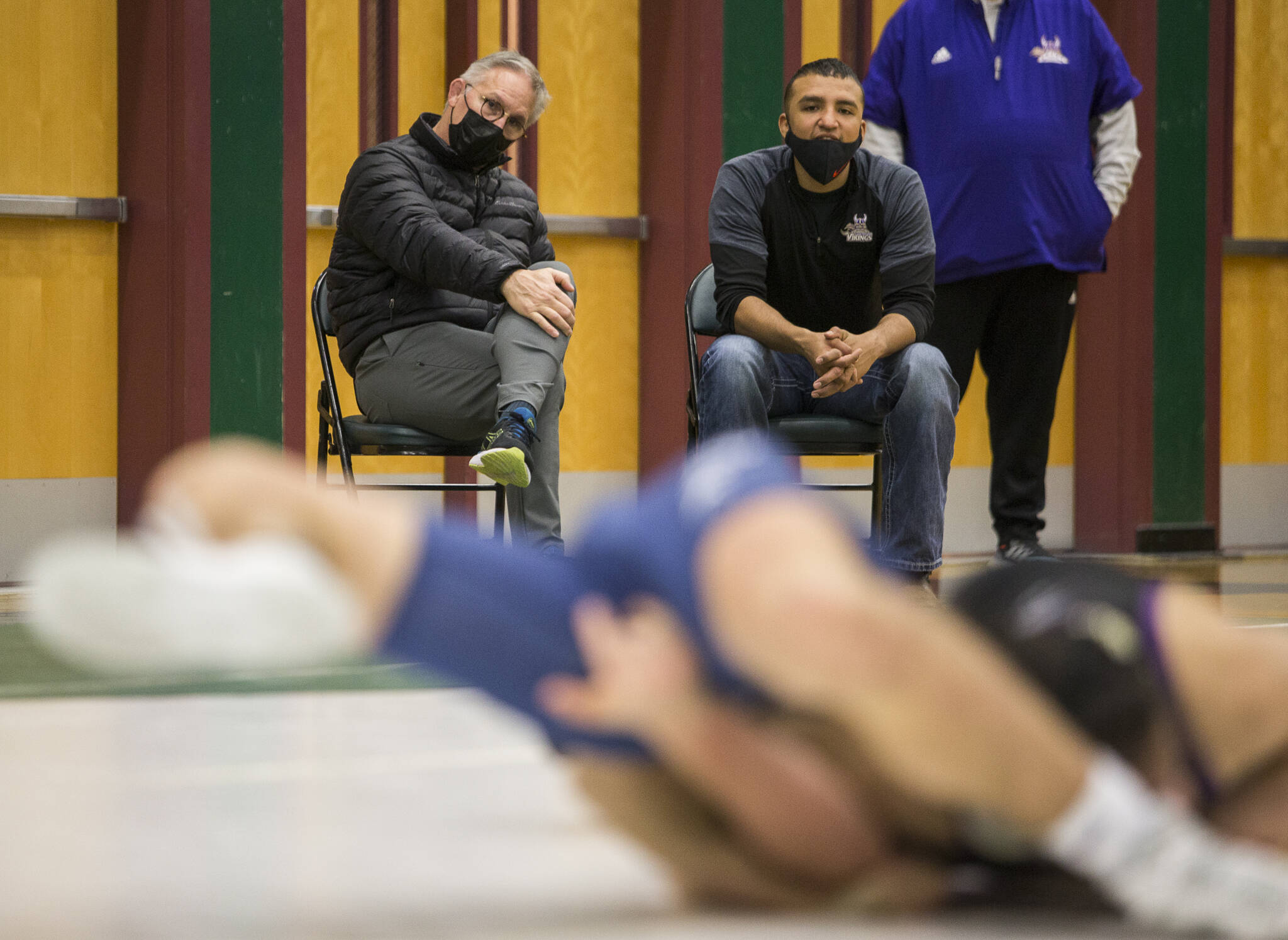 Lake Stevens head wrestling coach Brent Barnes (left) watches one of his wrestlers during at match at the Wesco 4A sub-regional tournament at Henry M. Jackson High School on Feb. 5 in Everett. (Olivia Vanni / The Herald)