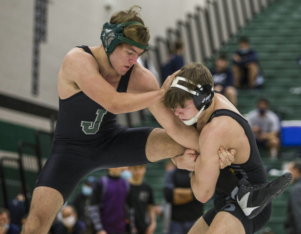 Lake Stevens’ Wyatt Springer grabs the leg of Jackson’s Jackson Salerno during the 4A sub-regional wrestling meet at Henry M. Jackson High School on Saturday, Feb. 5, 2022 in Everett, Wa. (Olivia Vanni / The Herald)
