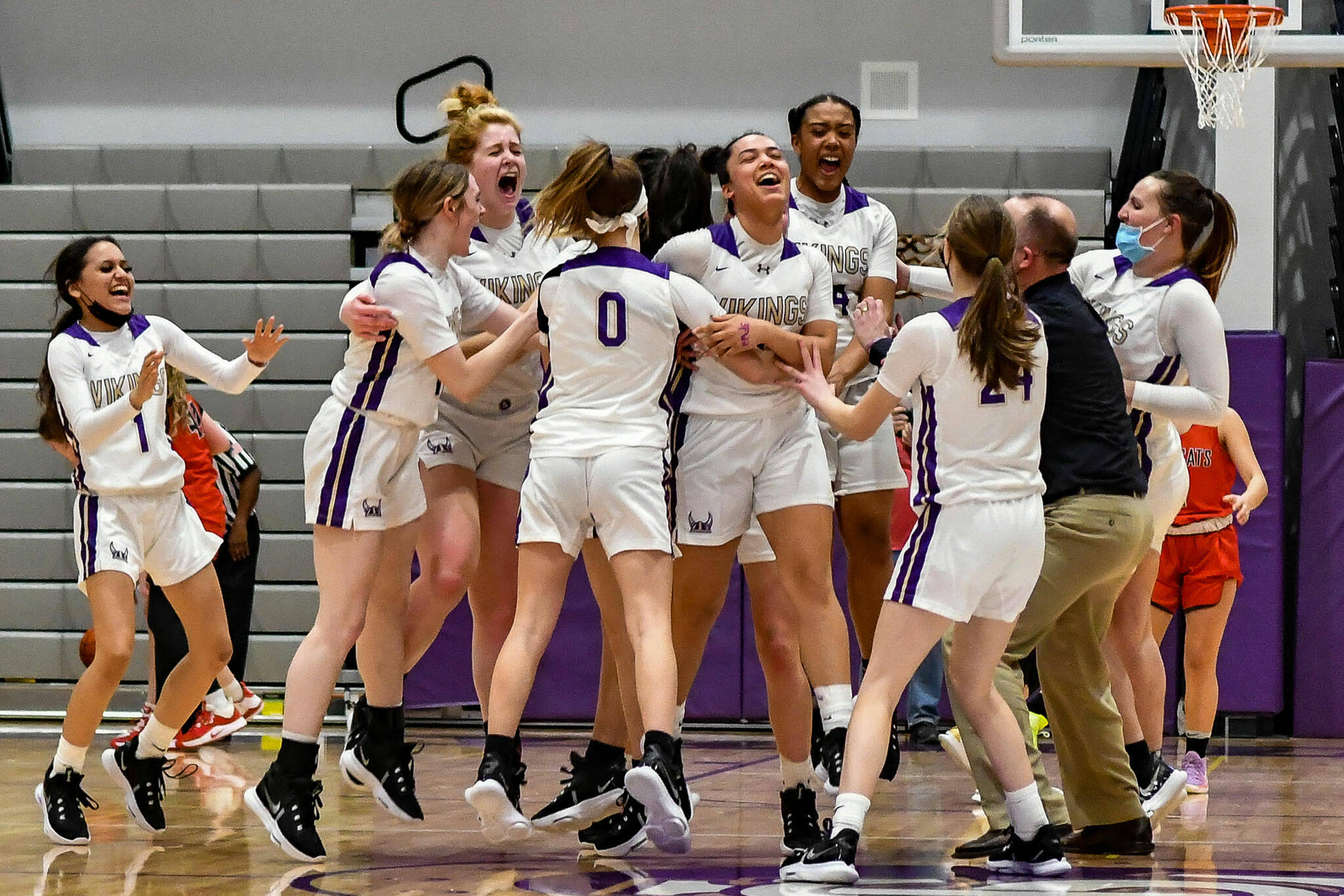 The Lake Stevens girls basketball team celebrates after beating Mount Si 58-57 in overtime of a 4A District 1/2 Tournament game on Friday, Feb. 11, 2022, at Lake Stevens High School. (John Gardner / Pro Action Image)