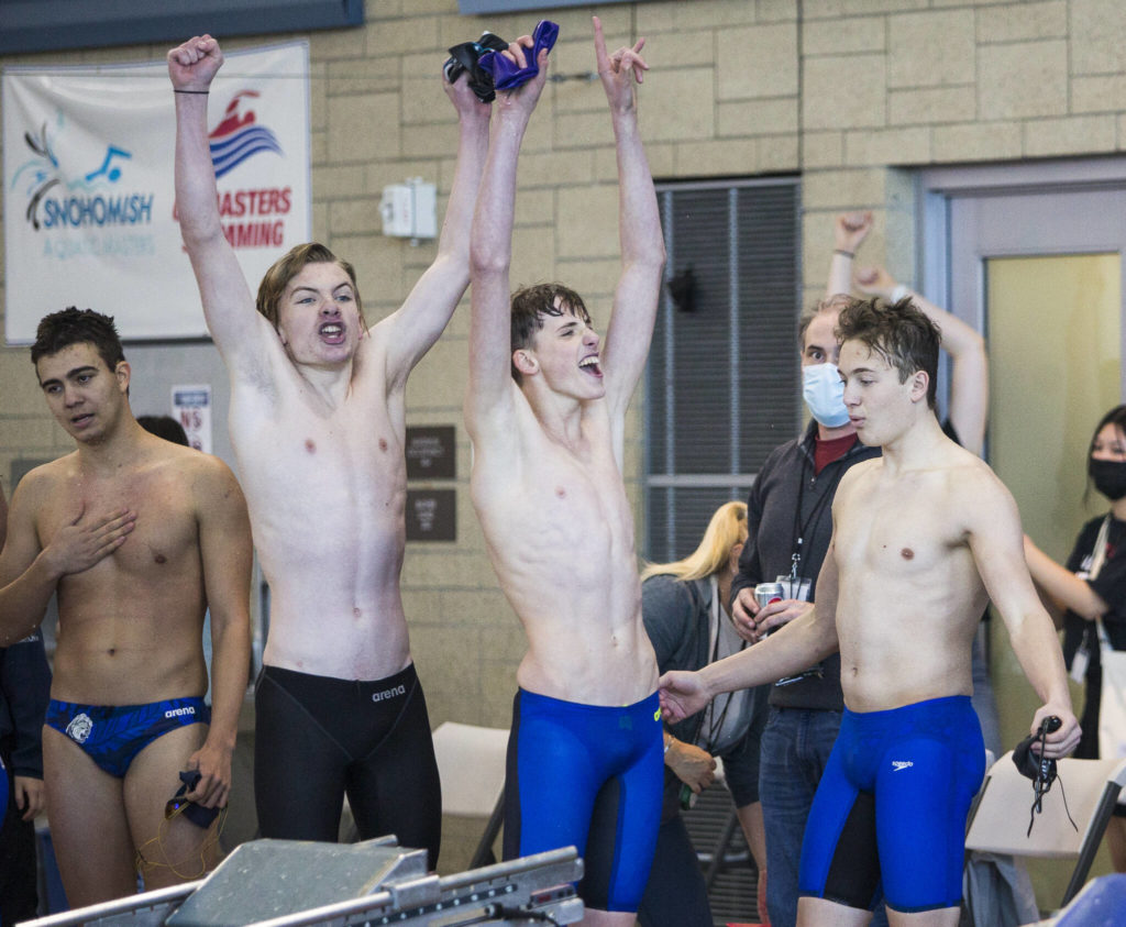 Lake Stevens swimmers react to their coach Brady Dykgraaf being named ԃoach of the Yearՠand winning the 4A Boys Districts swim meet on Saturday, Feb. 12, 2022 in Snohomish, Wa. (Olivia Vanni / The Herald)
