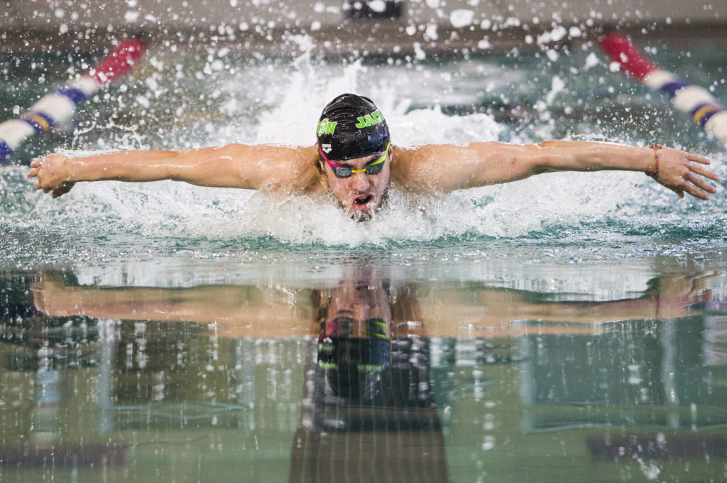 Alex Georgiev swims in the 100 Yard Butterfly during the 4A Boys Districts swim meet on Saturday, Feb. 12, 2022 in Snohomish, Wa. Georgiev won the 100 Yard Butterdly and set a new meet record. (Olivia Vanni / The Herald)
