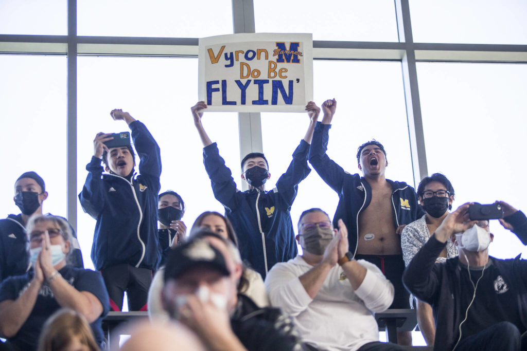 Mariner swimmers cheer on their teammate Vyron Domingo during his race at the 4A Boys Districts swim meet on Saturday, Feb. 12, 2022 in Snohomish, Wa. (Olivia Vanni / The Herald)
