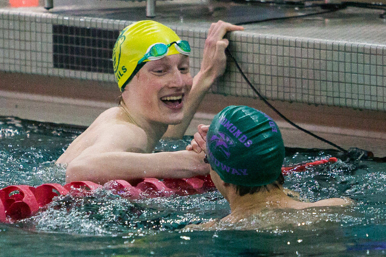 Shorecrest’s Sean Neils is congratulated by Edmonds-Woodway’s Mate Pallos for winning the 100 Yard Freestyle during the 3A Boys Districts swim meet on Saturday, Feb. 12, 2022 in Snohomish, Wa. (Olivia Vanni / The Herald)