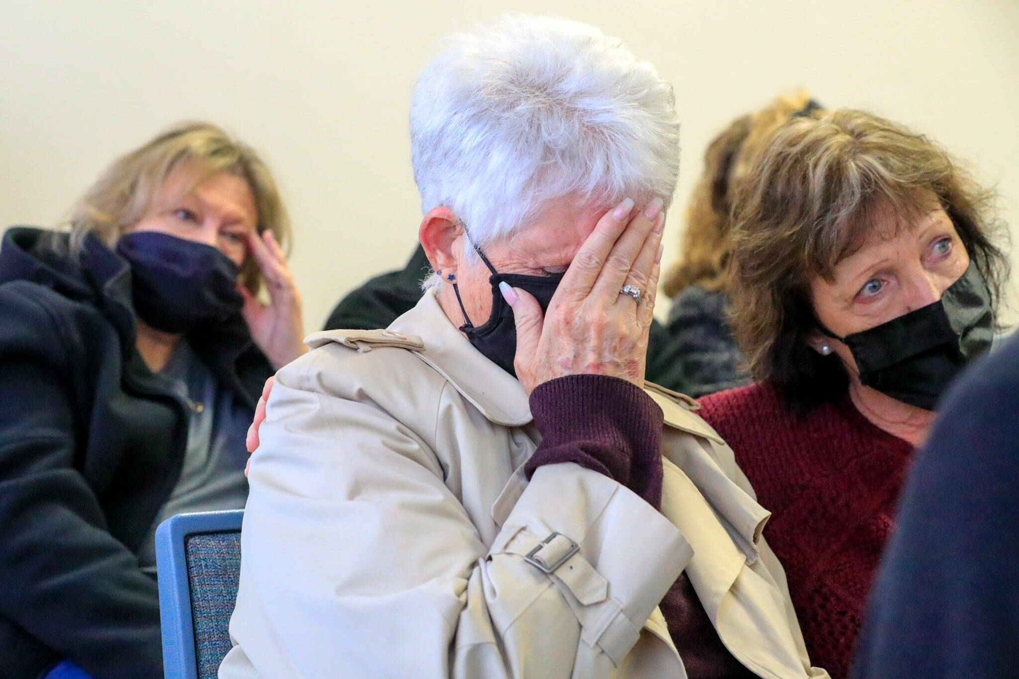 Lynn Sass (center) and Kim Cutts (right) listen as the judge hands down the sentence of Mark Abrahamson on Monday at the Snohomish County Superior Courthouse in Everett. (Kevin Clark / The Herald)