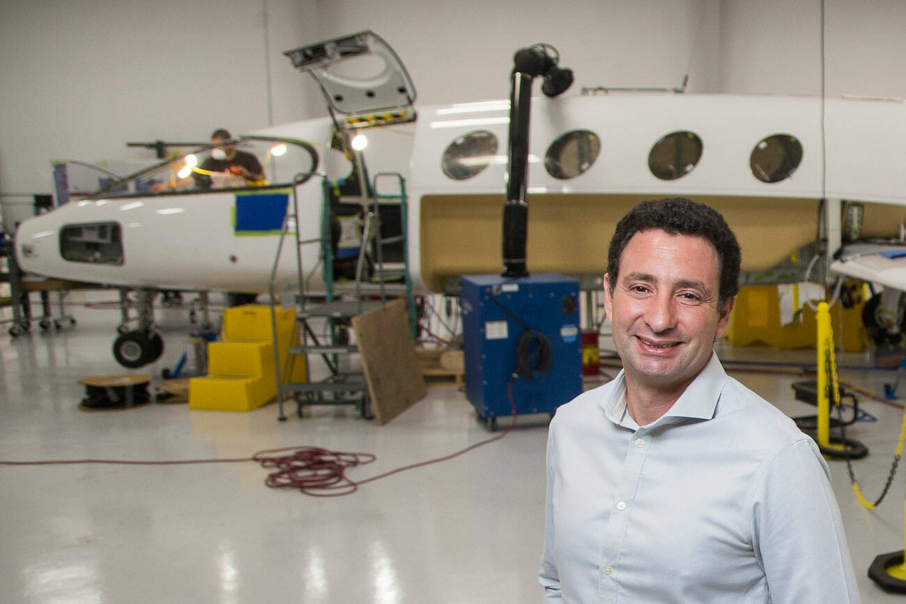 Eviation Co-founder and CEO Omer Bar-Yohay stands by the first all electric plane, the Alice, at Eviation's plant on Wednesday, Sept. 8, 2021 in Arlington, Washington.  (Andy Bronson / The Herald)