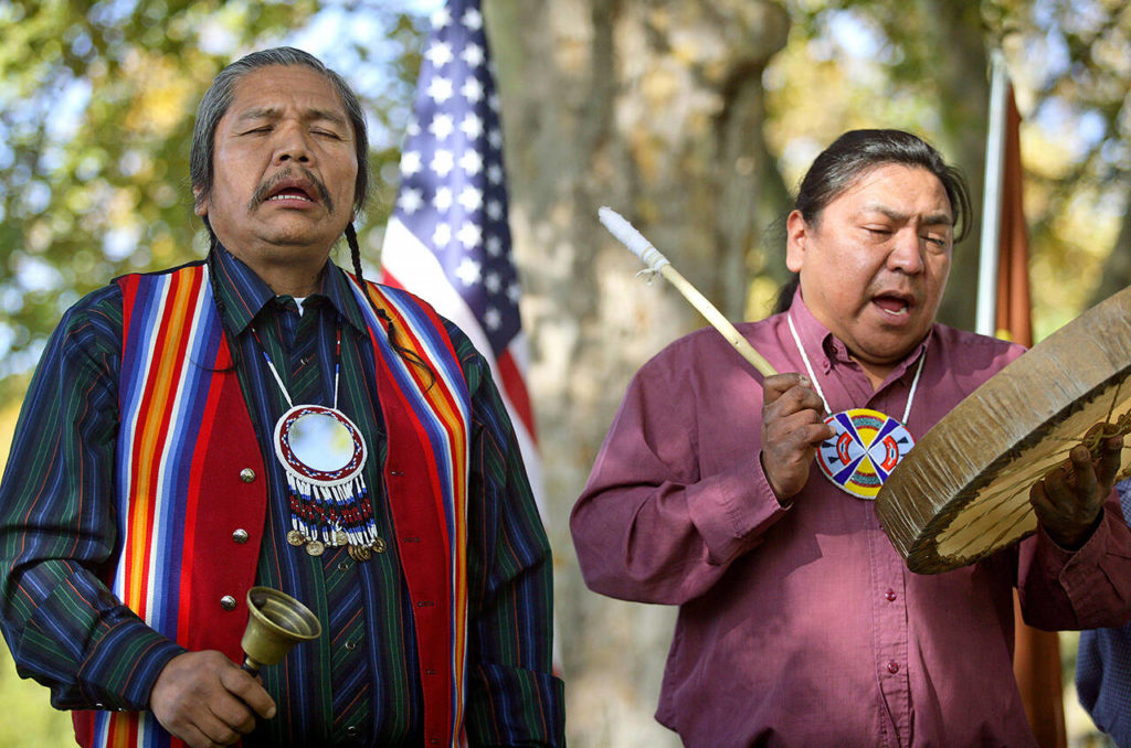 Rex Buck )left) of the Wanapum tribe and Thomas Morning Owl (right) of the Umatilla perform in a blessing ceremony to prepare Sacajawea State Park near Pasco for its future art installations on Oct. 27, 2006. (AP Photo/Jackie Johnston, file)
