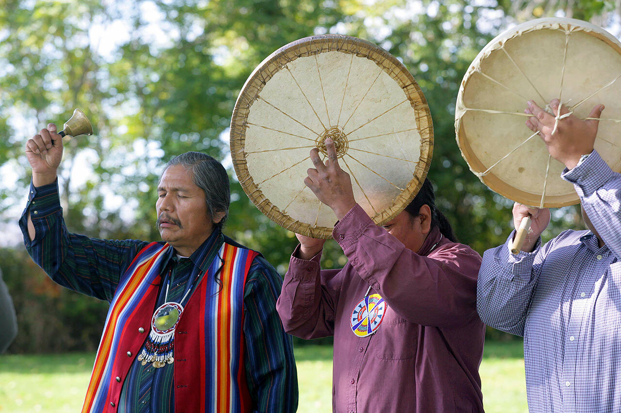 Rex Buck of the Wanapum tribe (left) rings a bell during a blessing ceremony to prepare Sacajawea State Park near Pasco for its future art installations on Oct. 27, 2006. (AP Photo/Jackie Johnston, file)