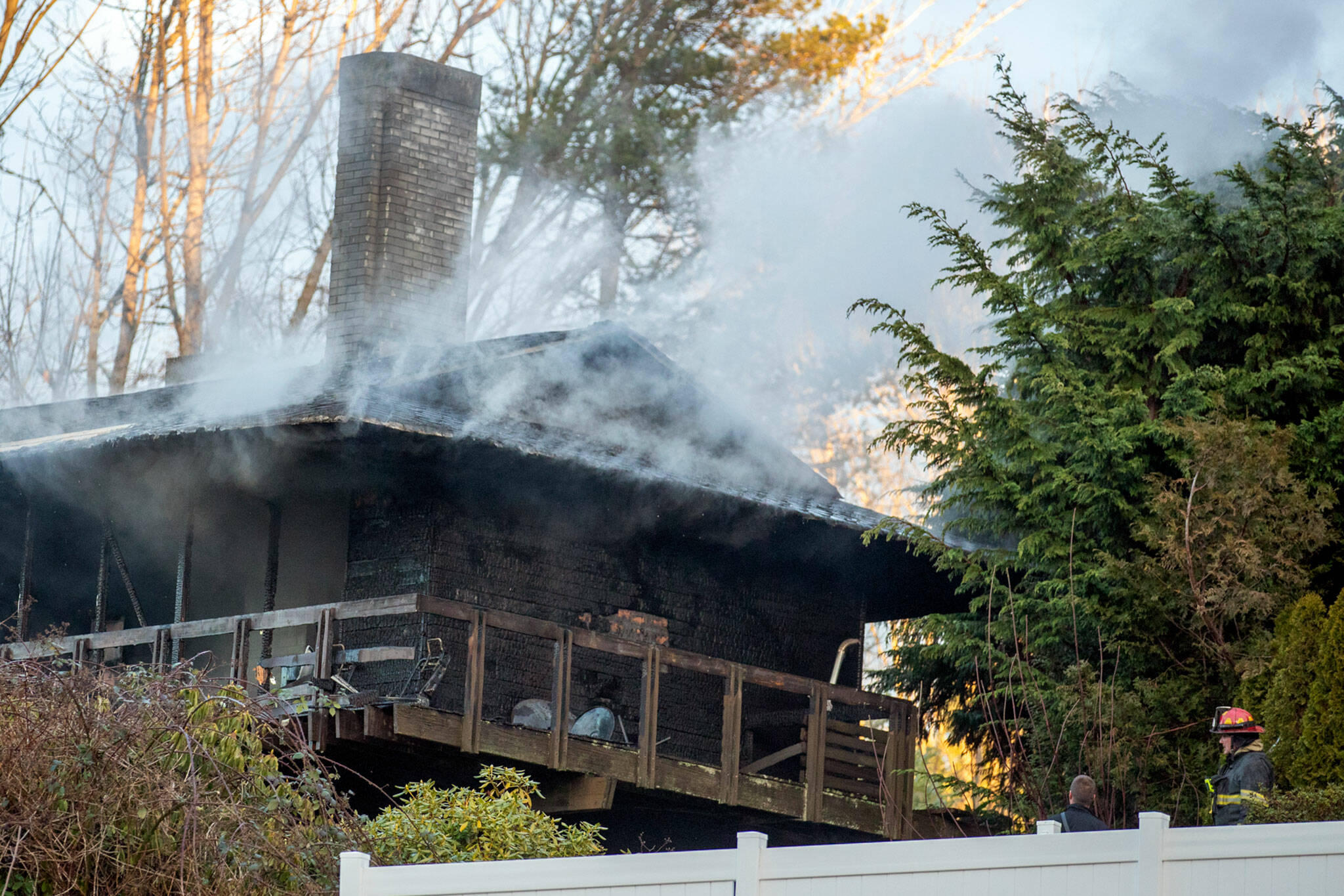 Smoke seeps from house fire in the 4100 block of Cliff Drive in Everett Monday. No injuries were reported. (Kevin Clark / The Herald )
