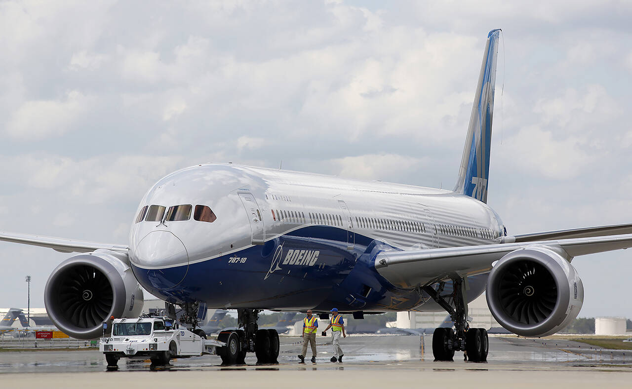 In this 2017 photo, Boeing employees walk the new Boeing 787-10 Dreamliner down towards the delivery ramp area at the company’s facility in South Carolina after conducting its first test flight at Charleston International Airport in North Charleston, South Carolina. (AP Photo/Mic Smith, File)