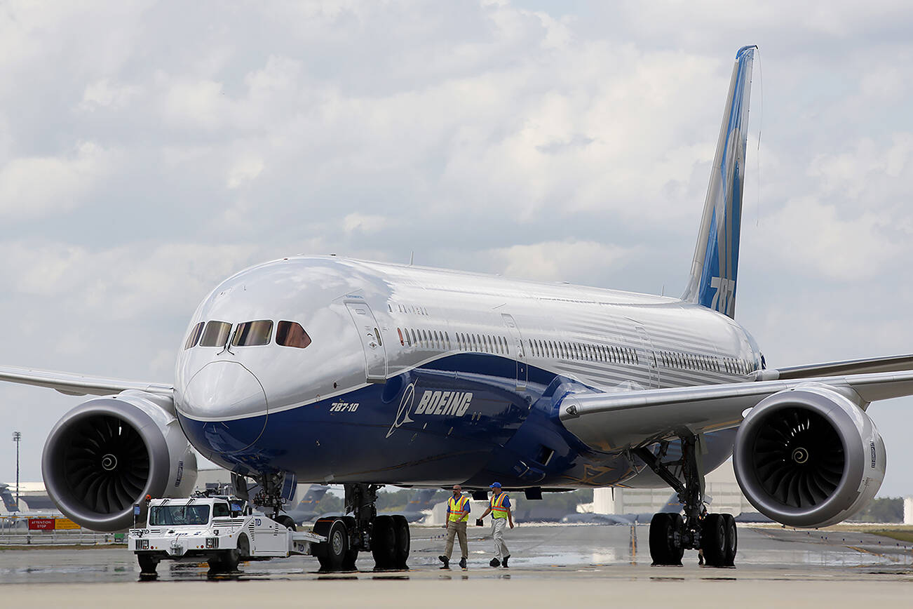 FILE - In this Friday, March 31, 2017, file photo, Boeing employees walk the new Boeing 787-10 Dreamliner down towards the delivery ramp area at the company's facility in South Carolina after conducting its first test flight at Charleston International Airport in North Charleston, S.C. Federal safety officials aren't ready to give back authority for approving new planes to Boeing when it comes to the large 787 jet, which Boeing calls the Dreamliner, Tuesday, Feb. 15, 2022. The plane has been plagued by production flaws for more than a year.(AP Photo/Mic Smith, File)