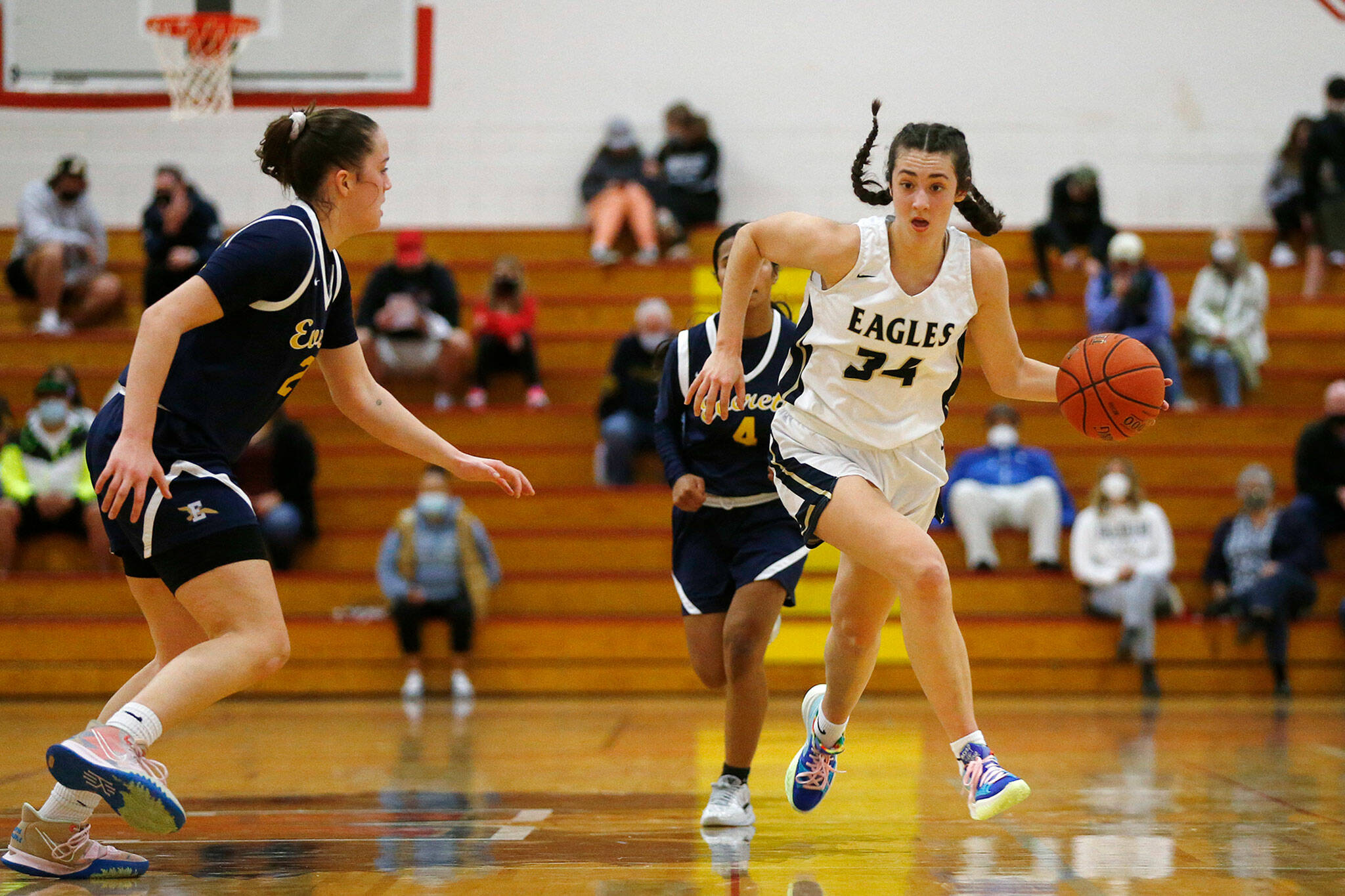 Arlington’s Jenna Villa takes the ball up the court against Everett Tuesday, Feb. 15, 2022, at Marysville Pilchuck High School in Marysville, Washington. (Ryan Berry / The Herald)