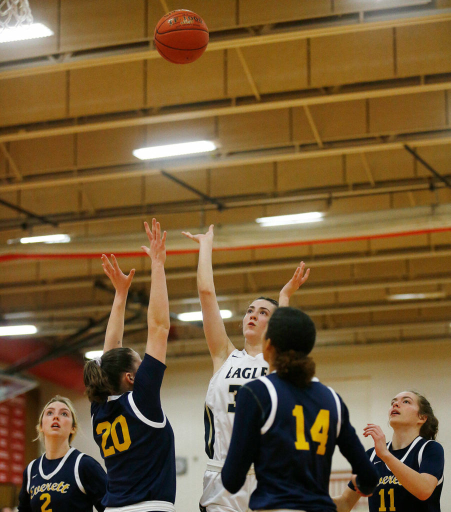 Arlington’s Jenna Villa hits the floater over multiple defenders against Everett Tuesday, Feb. 15, 2022, at Marysville Pilchuck High School in Marysville, Washington. (Ryan Berry / The Herald)
