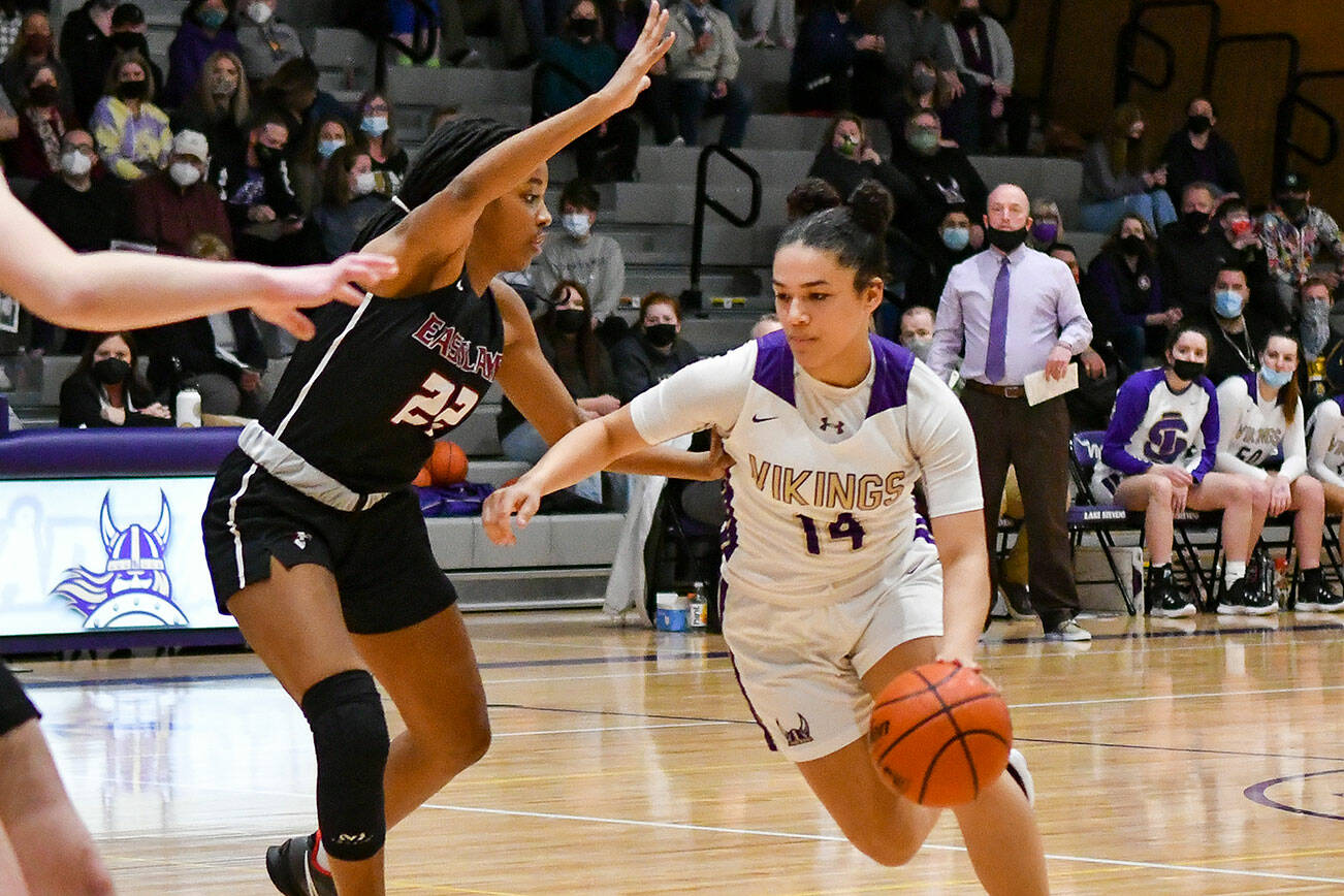 Lake Stevens' Baylor Thomas (14) with drives to the basket with Eastlake's Kaylia Jackson defending during a Class 4A Wes-King Bi-District semifinal game Tuesday, Feb. 15, 2022, at Lake Stevens High School. (John Gardner / Pro Action Image)