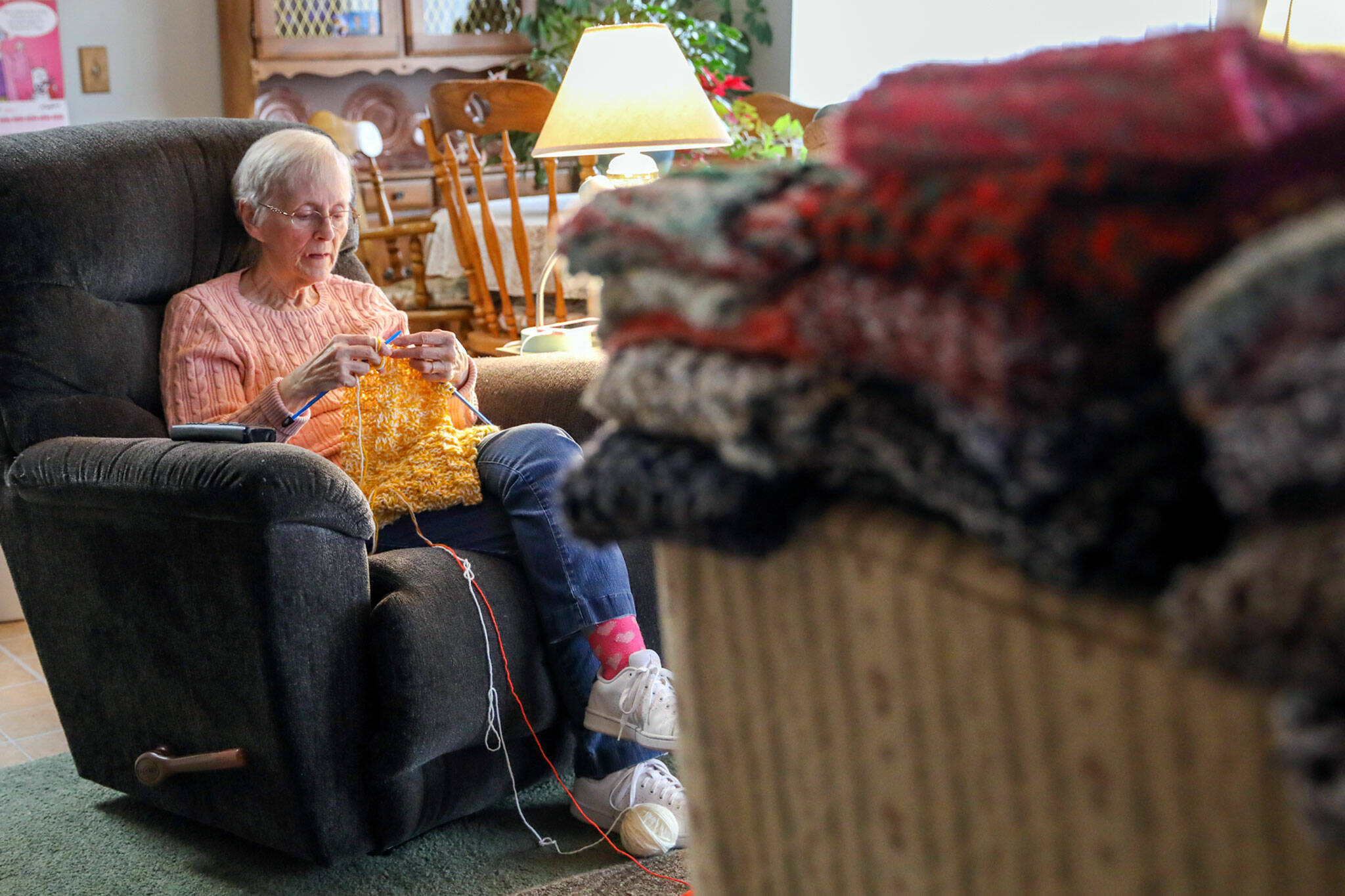 Vicki Wahl knits scarves at her home in Lake Stevens on Feb. 17. More than 170 of her scarves will be handed out during this years’ homelessness count. (Kevin Clark / The Herald )