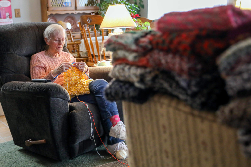 Vicki Wahl knits scarves at her home in Lake Stevens on Feb. 17. More than 170 of her scarves will be handed out during this years’ homelessness count. (Kevin Clark / The Herald )
