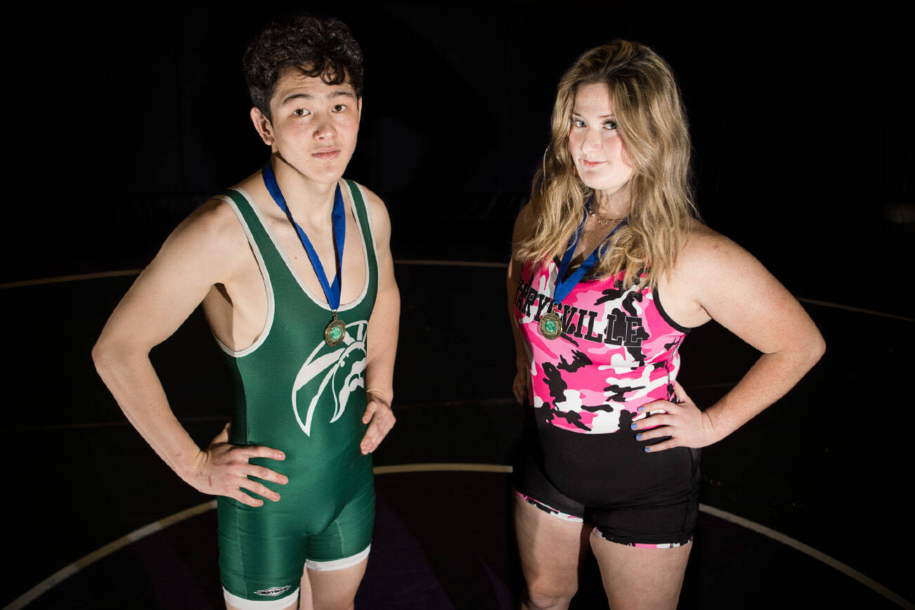 Snohomish County's returning state wrestling champions, Alex Rapelje of Edmonds-Woodway (left) and Alivia White of Marysville Pilchuck (right). (Olivia Vanni / The Herald)