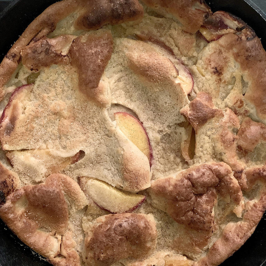 Reporter Taylor Goebel made this peach Dutch baby (recipe from Half Baked Harvest) for her friends after a harrowing hiking excursion in New Hampshire’s White Mountains. (Taylor Goebel / The Herald)
