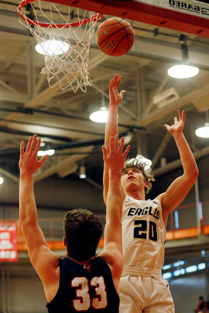 Arlington’s Gage Price puts up a shot against Mountlake Terrace during a 3A District 1 Tournament semifinal game on Wednesday at Everett Community College. (Ryan Berry / The Herald)
