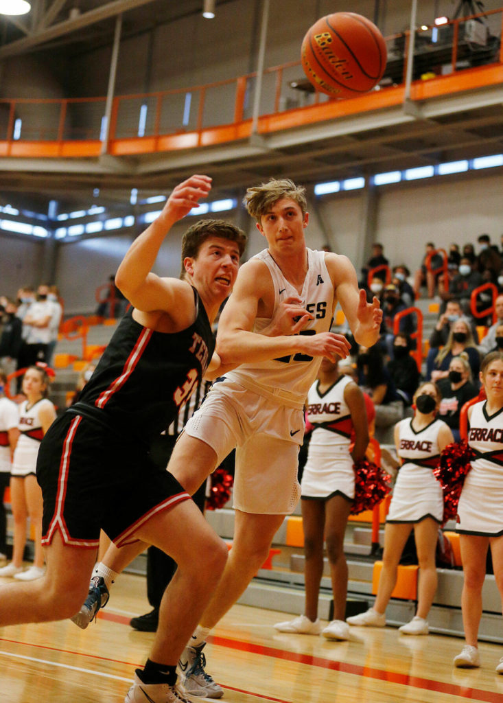 Arlington and Mountlake Terrace players chase after a loose ball out of bounds during a 3A District 1 Tournament semifinal game on Wednesday at Everett Community College. (Ryan Berry / The Herald)
