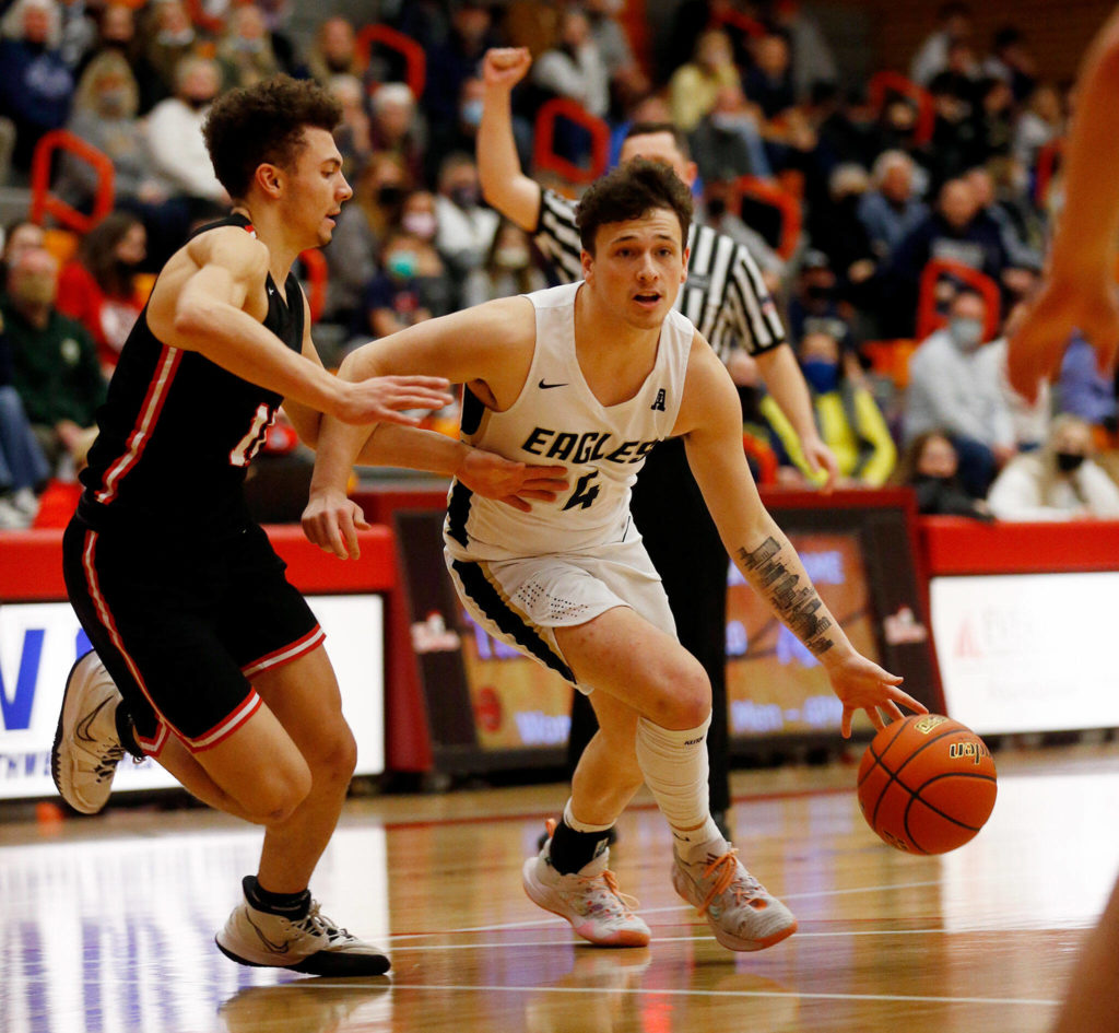 Arlington’s Grayson Falk gets fouled as he drives on a defender against Mountlake Terrace during a 3A District 1 Tournament semifinal game on Wednesday at Everett Community College. (Ryan Berry / The Herald)

