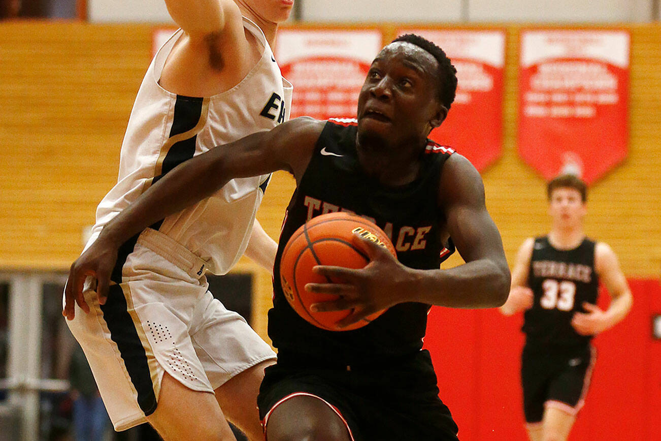 Mountlake Terrace’s Jeffrey Anyimah gets past a defender on his way to the basket against Arlington during a 3A District 1 Tournament semifinal game on Wednesday at Everett Community College. (Ryan Berry / The Herald)
