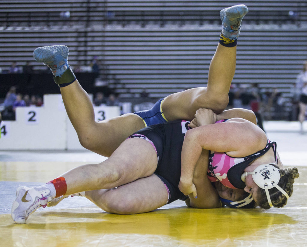 Marysville Pilchuck’s Alivia White flips and pins Burlington’s Delaney Cobbs during the Girls 190-pound championship match at the Mat Classic XXXIII on Saturday in Tacoma. (Olivia Vanni / The Herald)
