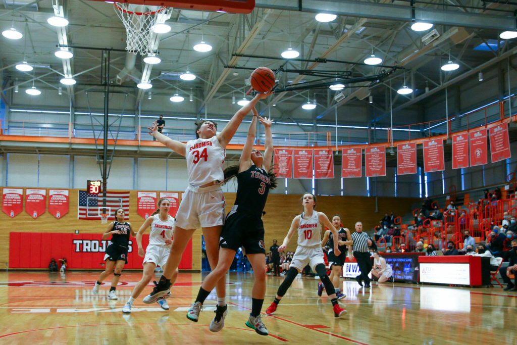 Snohomish’s Tyler Gildersleeve-Stiles, left and Mountlake Terrace’s Ainsley Ward jump for a rebound Saturday afternoon at during the 3A District Tournament at Everett Community College in Everett, Washington on February 19, 2022. (Kevin Clark / The Herald )
