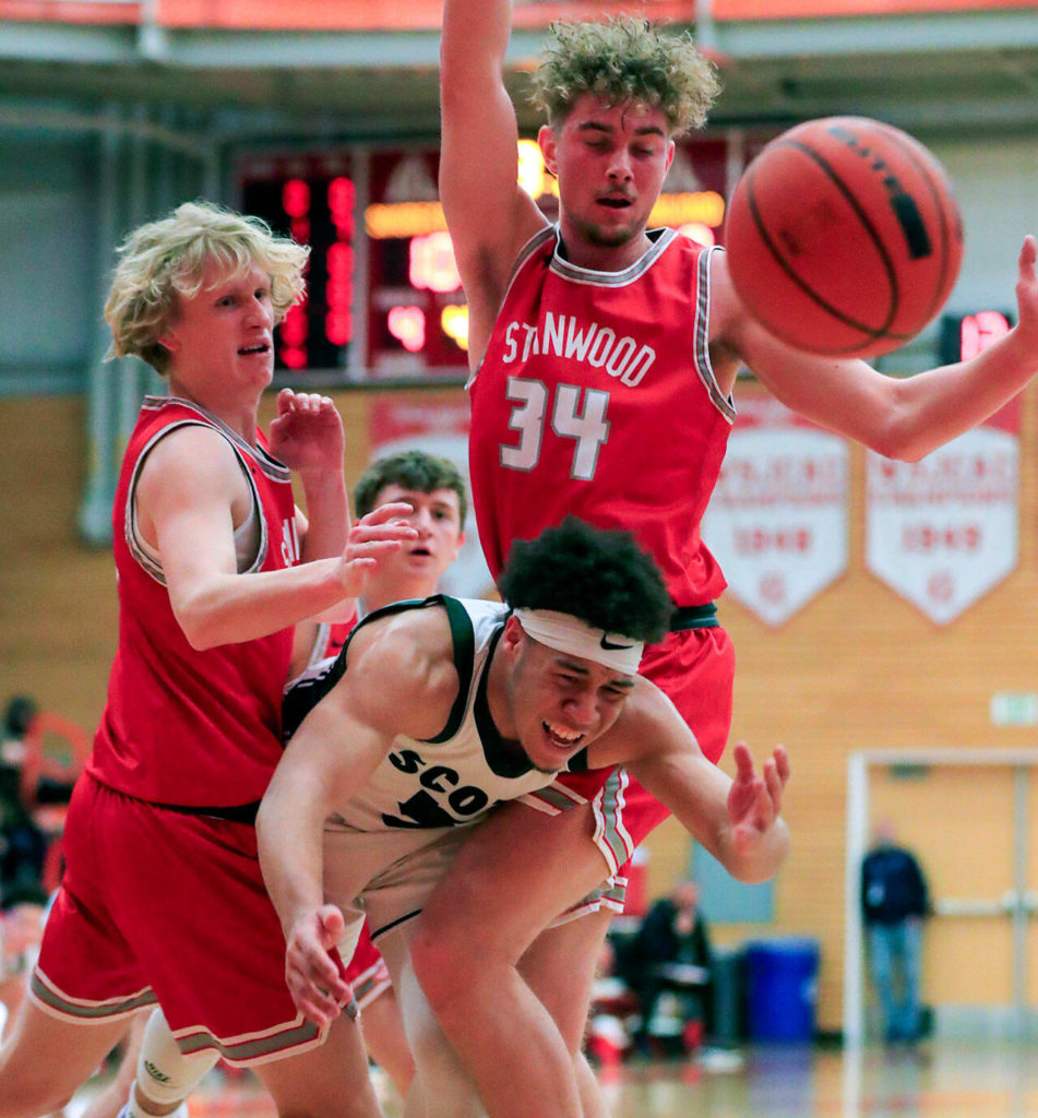 Shorecrest’s Elijah Johnson is fouled attempting to split the defensive pressure of Stanwood Saturday afternoon at during the 3A District Tournament at Everett Community College in Everett, Washington on February 19, 2022. (Kevin Clark / The Herald )

