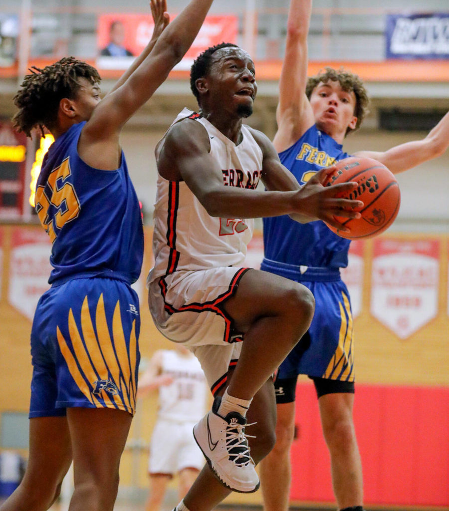 Mountlake Terrace’s Jeffrey Anyimah splits Ferndale’s defense for a layup Saturday evening at during the 3A District Tournament at Everett Community College in Everett, Washington on February 19, 2022. (Kevin Clark / The Herald )

