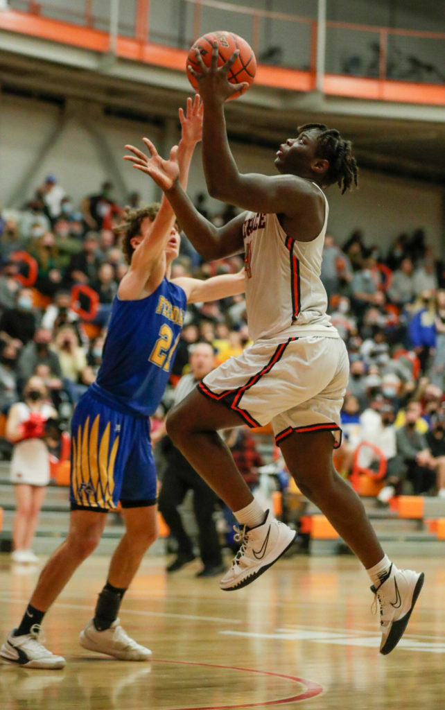 Mountlake Terrace’s Zaveon Jones jumps for layup with Ferndale’s Conner Walcker defending Saturday evening at during the 3A District Tournament at Everett Community College in Everett, Washington on February 19, 2022. (Kevin Clark / The Herald )
