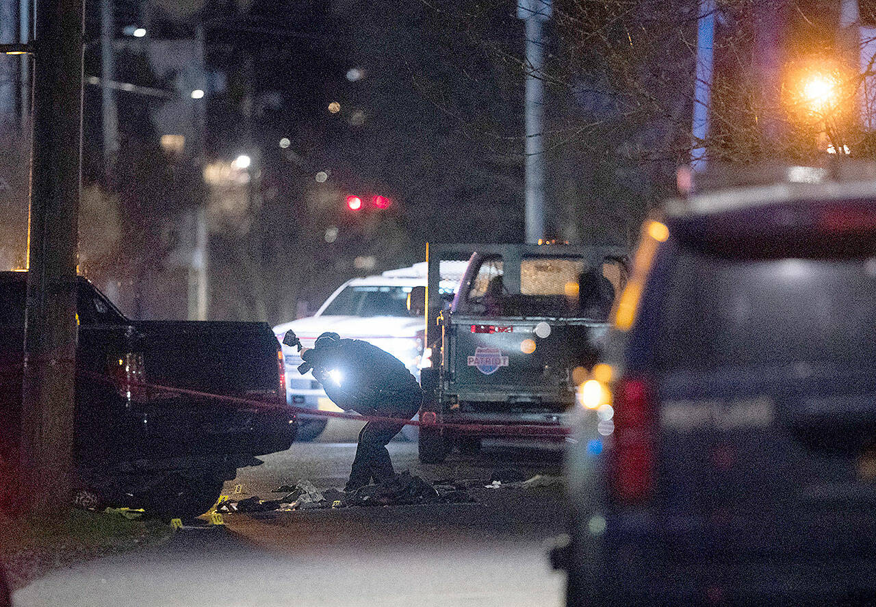 Portland police respond to a shooting Saturday in the area of Normandale Park in Northeast Portland, Ore. One person was killed and five others were wounded in a shooting at the Portland park where a march was planned to protest police violence. (Beth Nakamura/The Oregonian via AP)